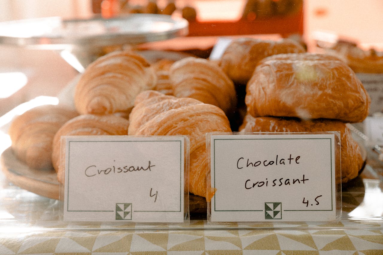 services-02 Delicious croissants and chocolate croissants elegantly displayed at a bakery.
