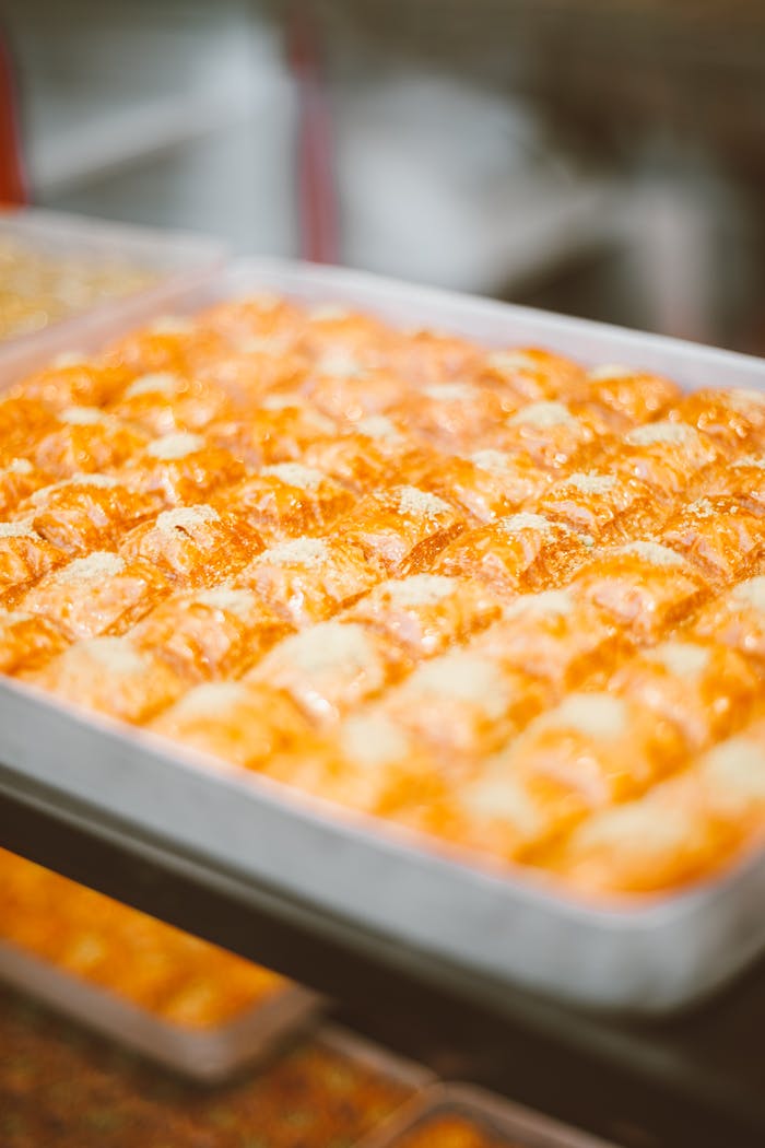 services-01 Rows of delicious golden pastries on a tray, perfect for culinary photography.